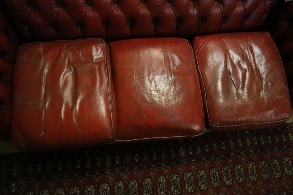 A buttoned red leather Chesterfield settee, width 194cm, depth 82cm, height 72cm